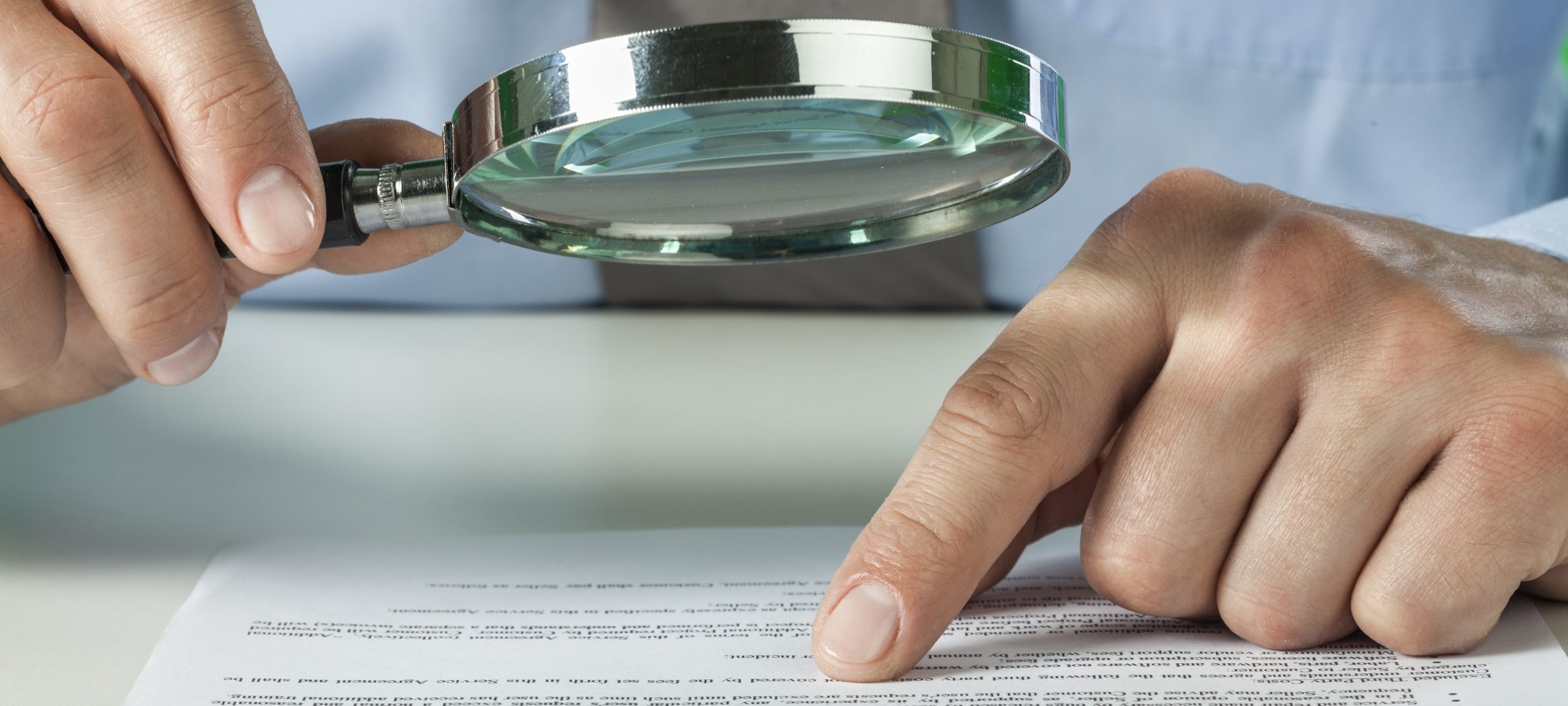 Man reading with magnifying glass